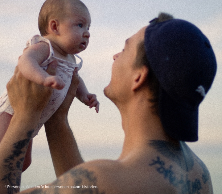back-tattoos-cap-holding-baby
